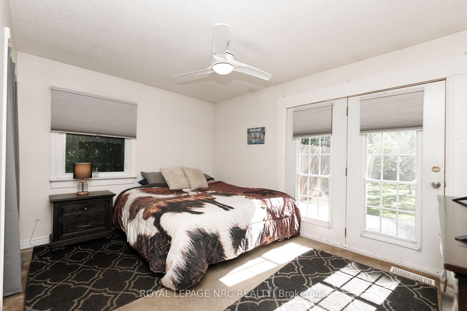Spacious primary bedroom with French Door walk-out