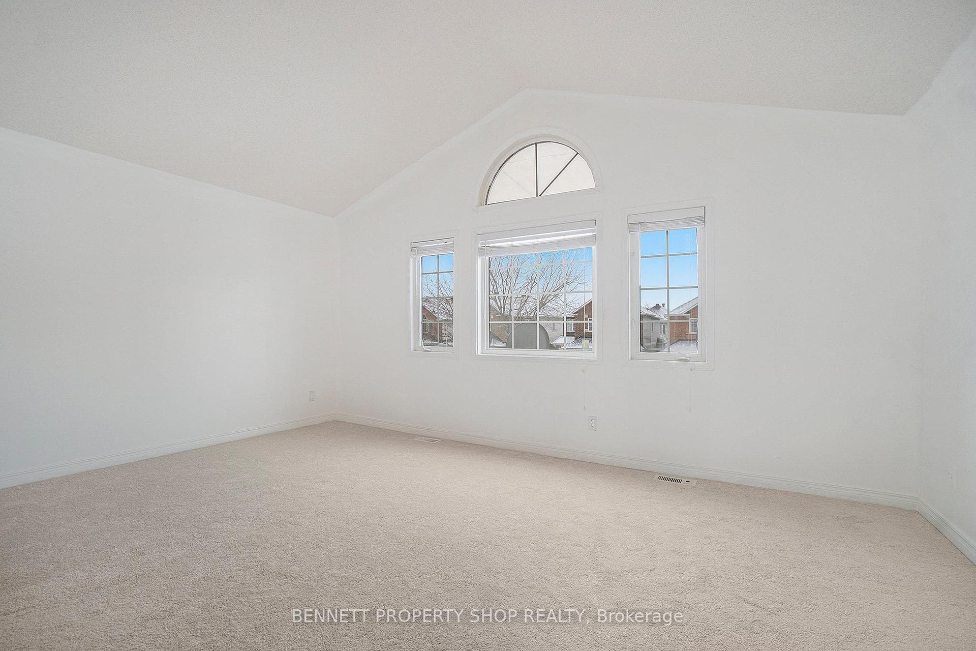 Spacious primary bedroom with cathedral ceilings