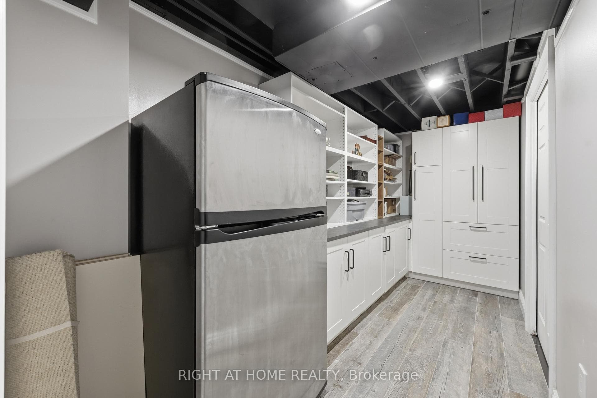 Storage Room in basement with fridge.
