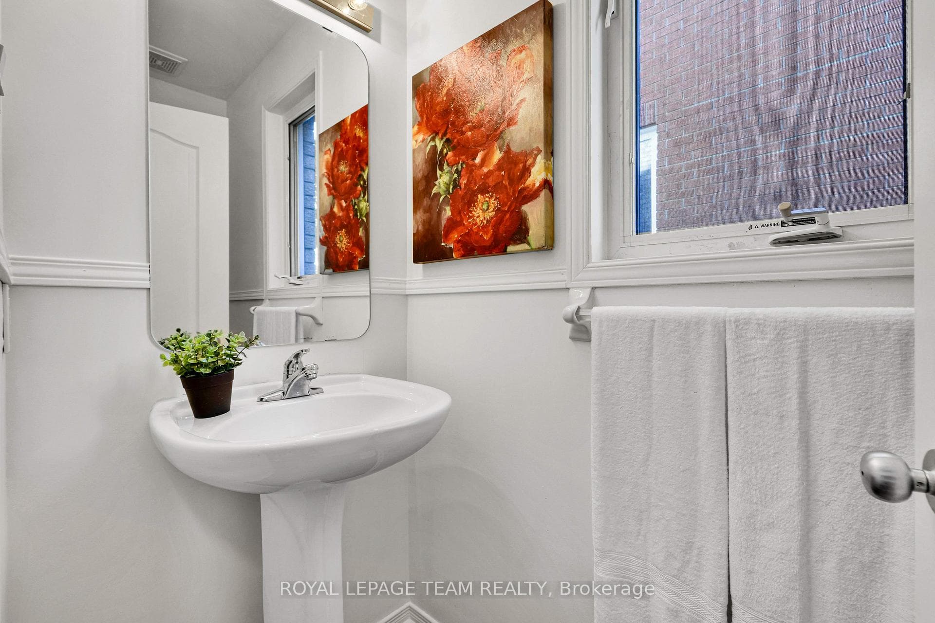 MAIN FLOOR POWDER ROOM OFF HALL.