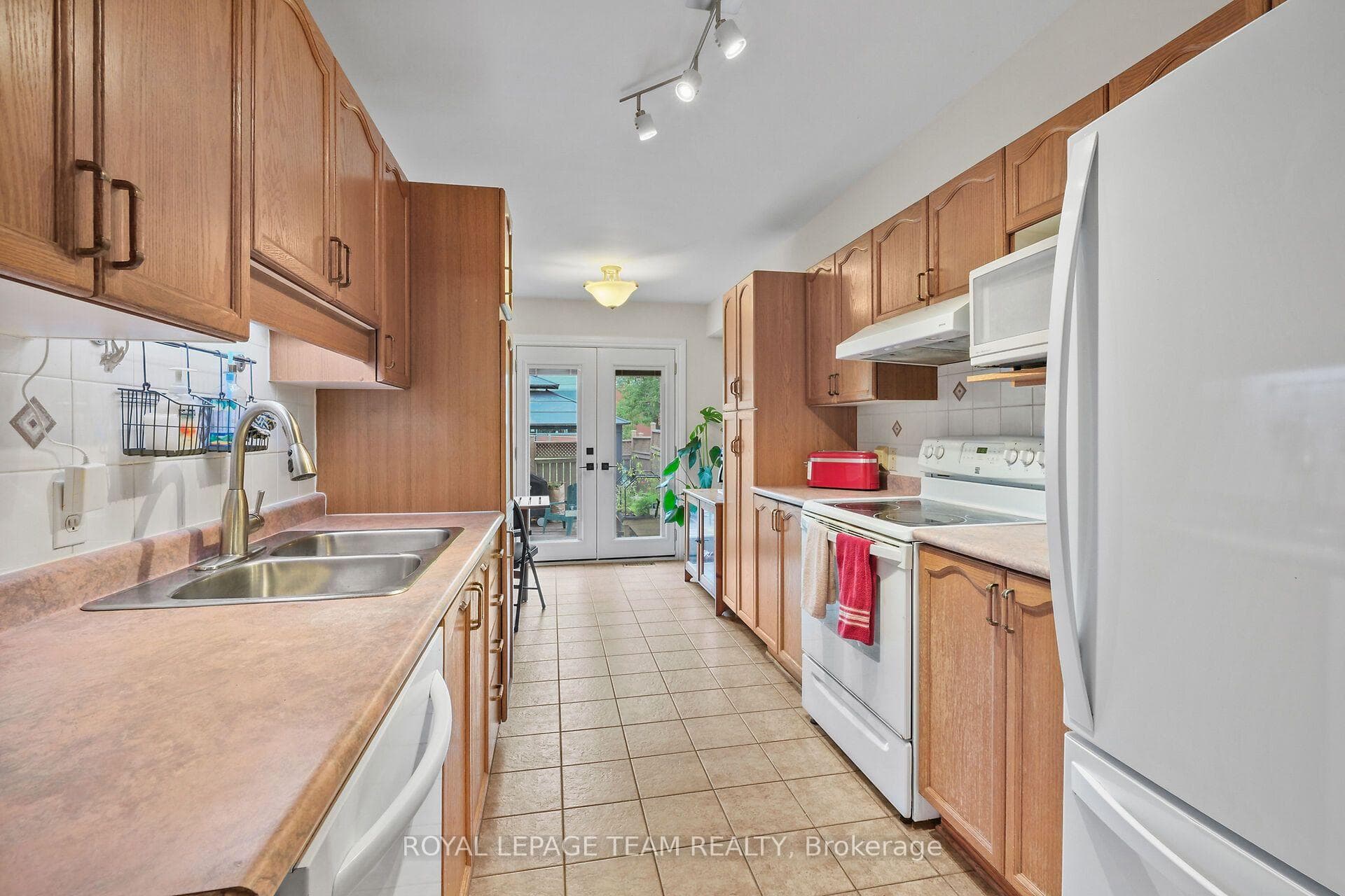 Ample natural light in Kitchen from patio doors.