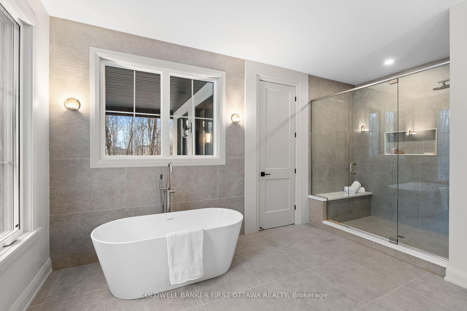Deep soaker tub & glass enclosed rain shower.