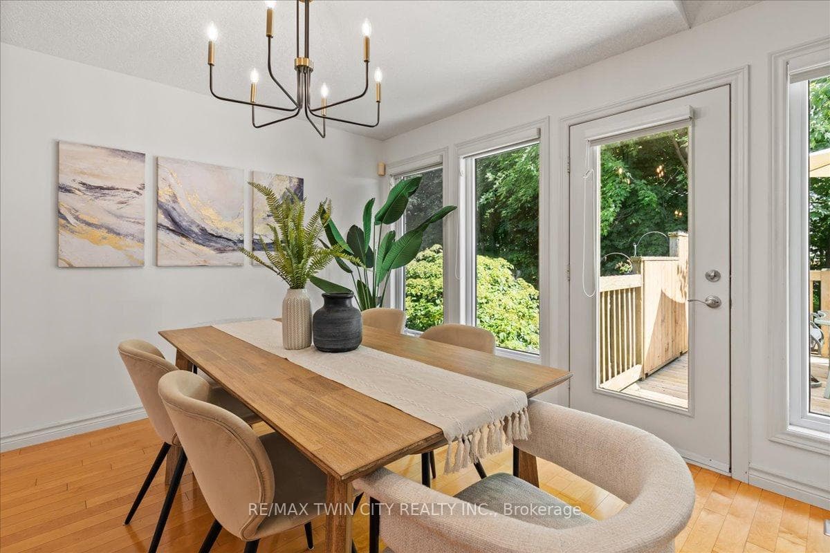 Dining rm with treed view, and walk-out to deck.