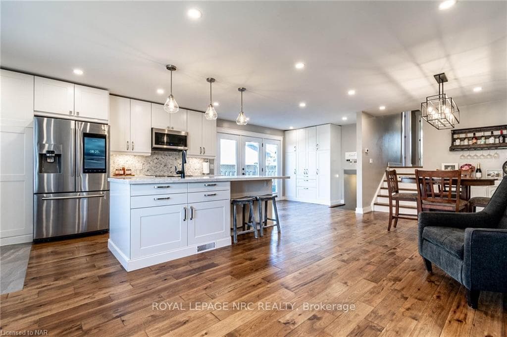 Kitchen with white cabinets, decorative light fixt