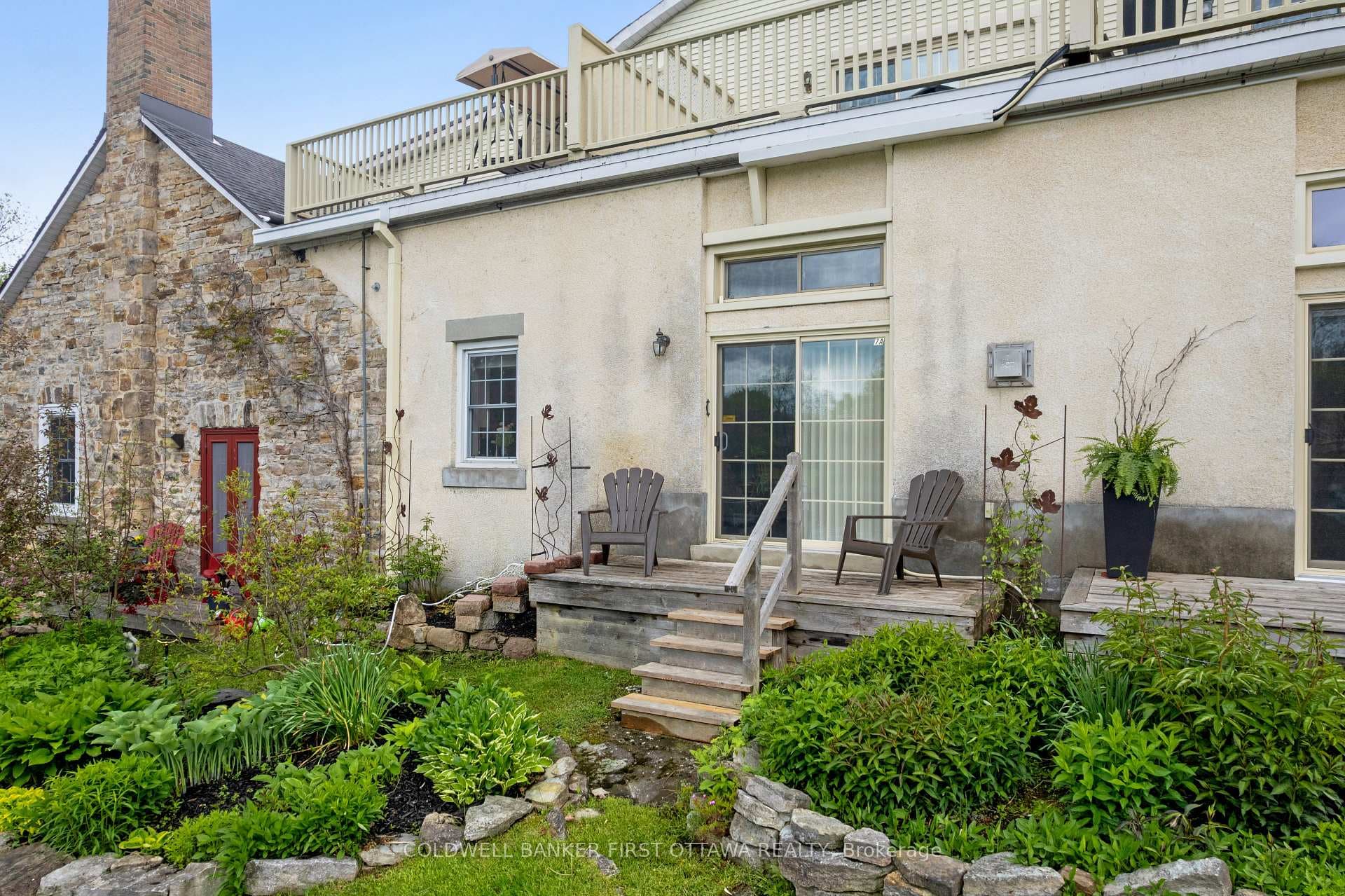 Deck off living room overlooking gardens and river