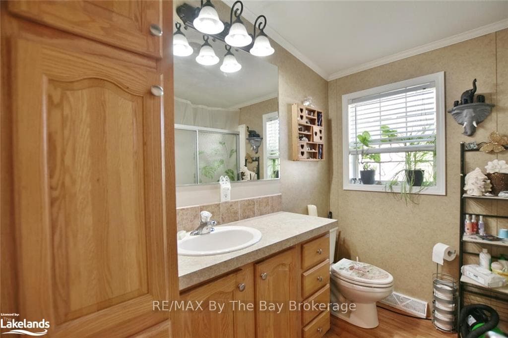 Bathroom with ornamental molding, hardwood / wood-