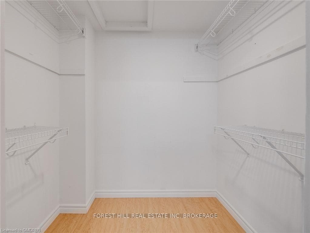 Spacious closet with hardwood / wood-style floors