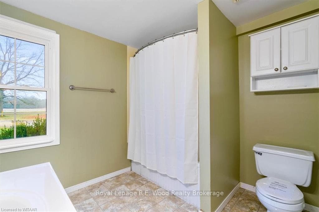 Bathroom with shower / bath combo and toilet