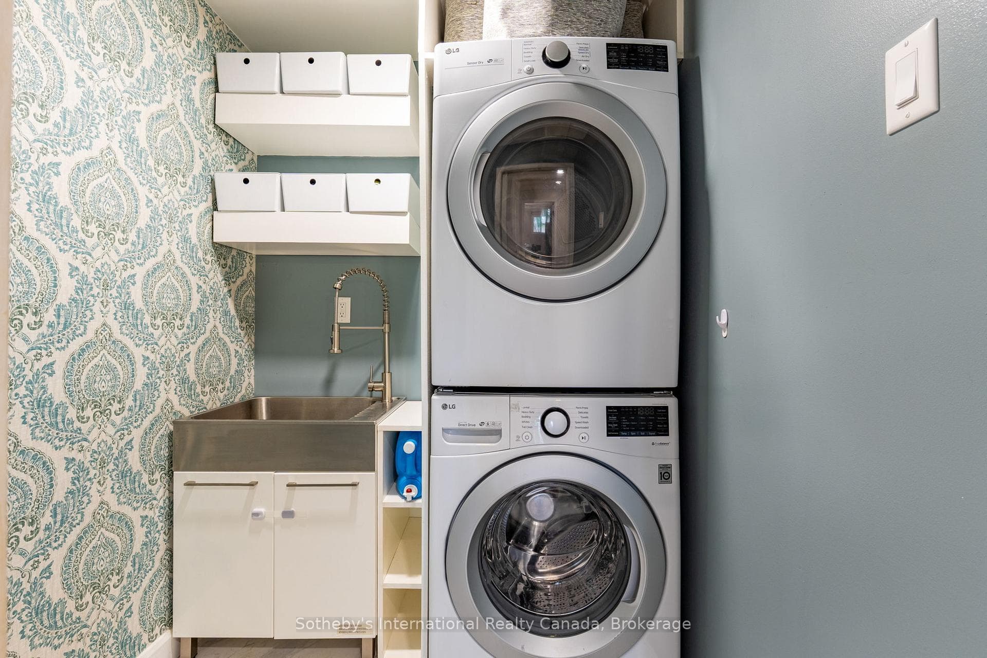 Laundry room with stackables & utility sink.