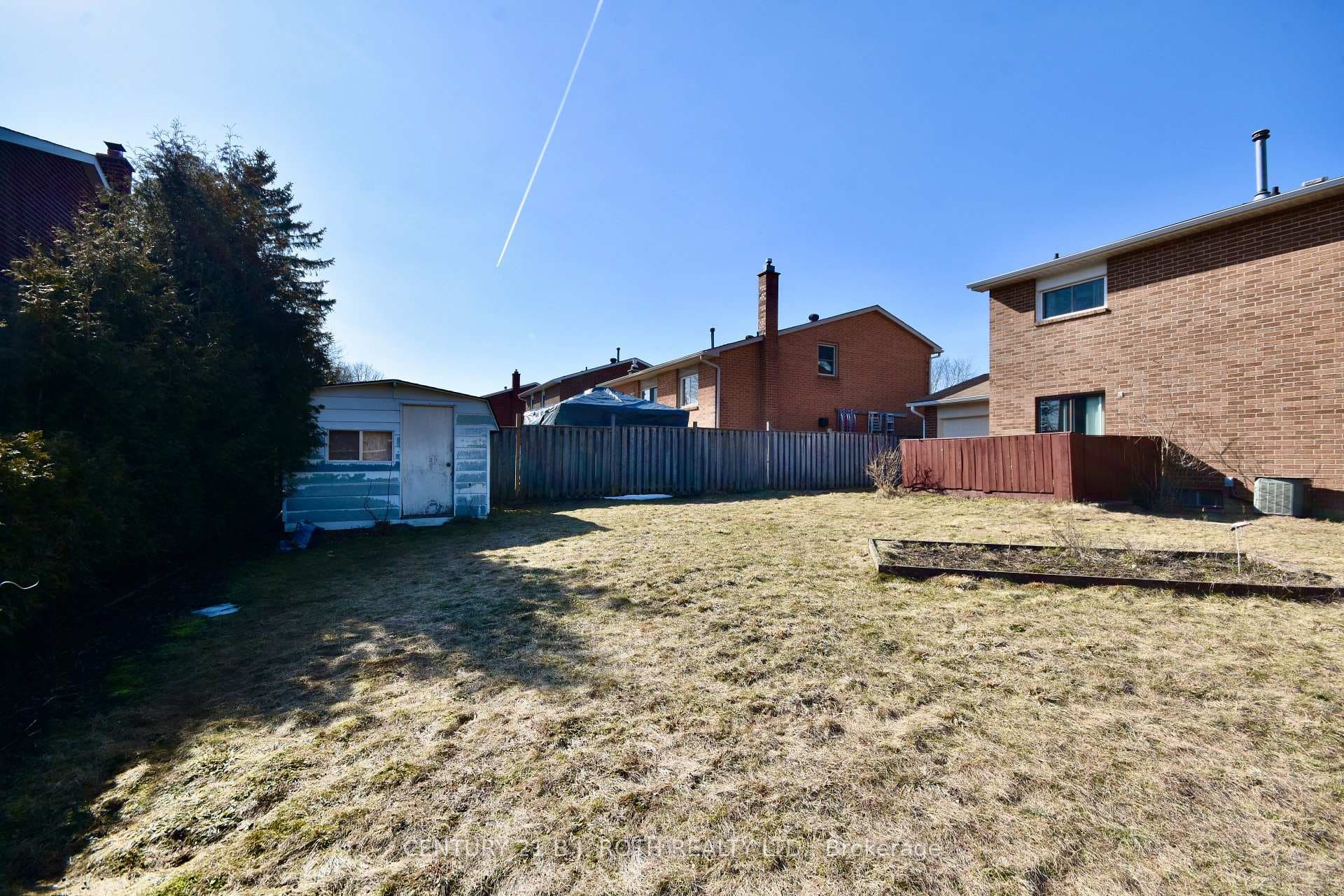 Fully fenced backyard with shed