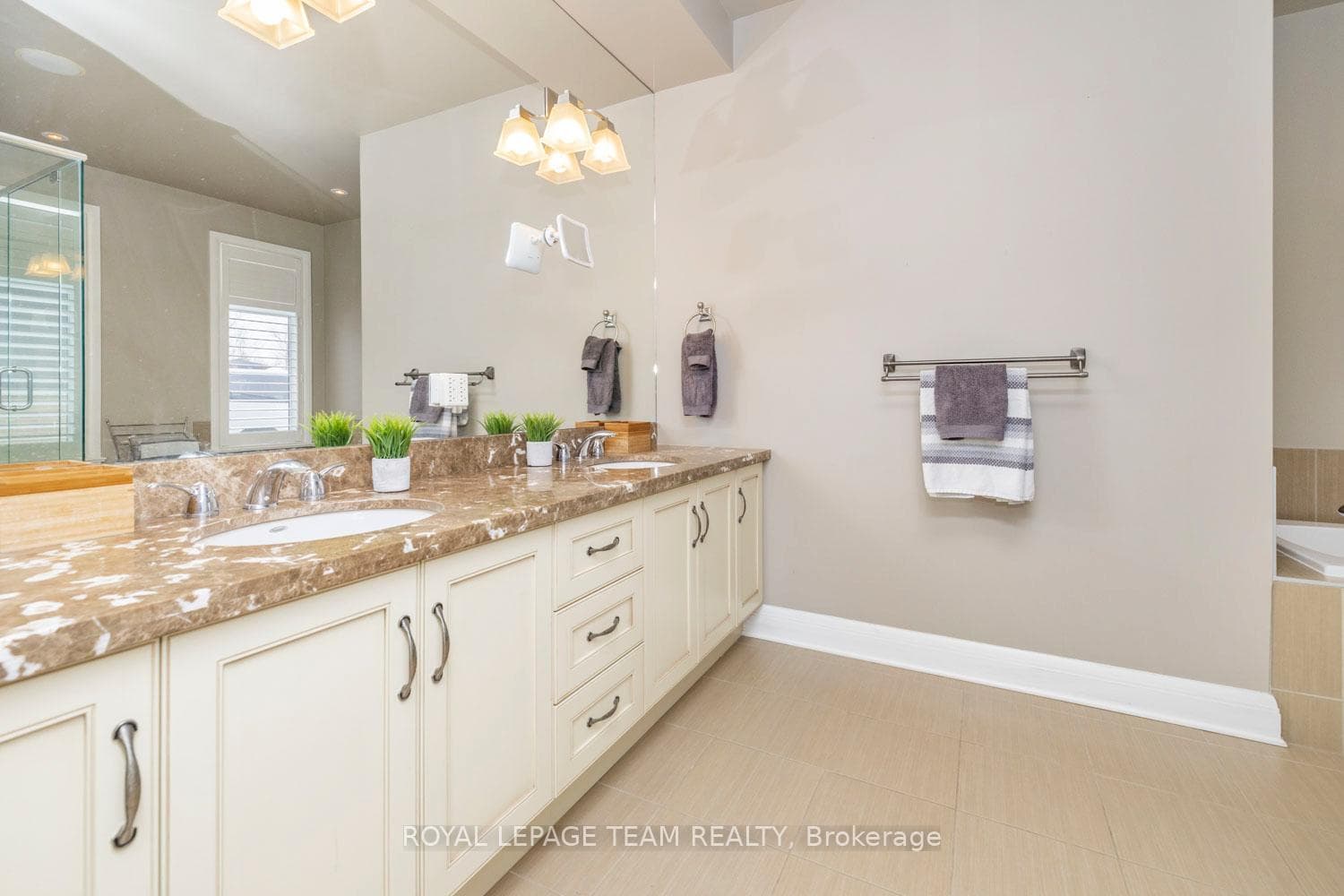 Ensuite with dual sinks and granite vanity.