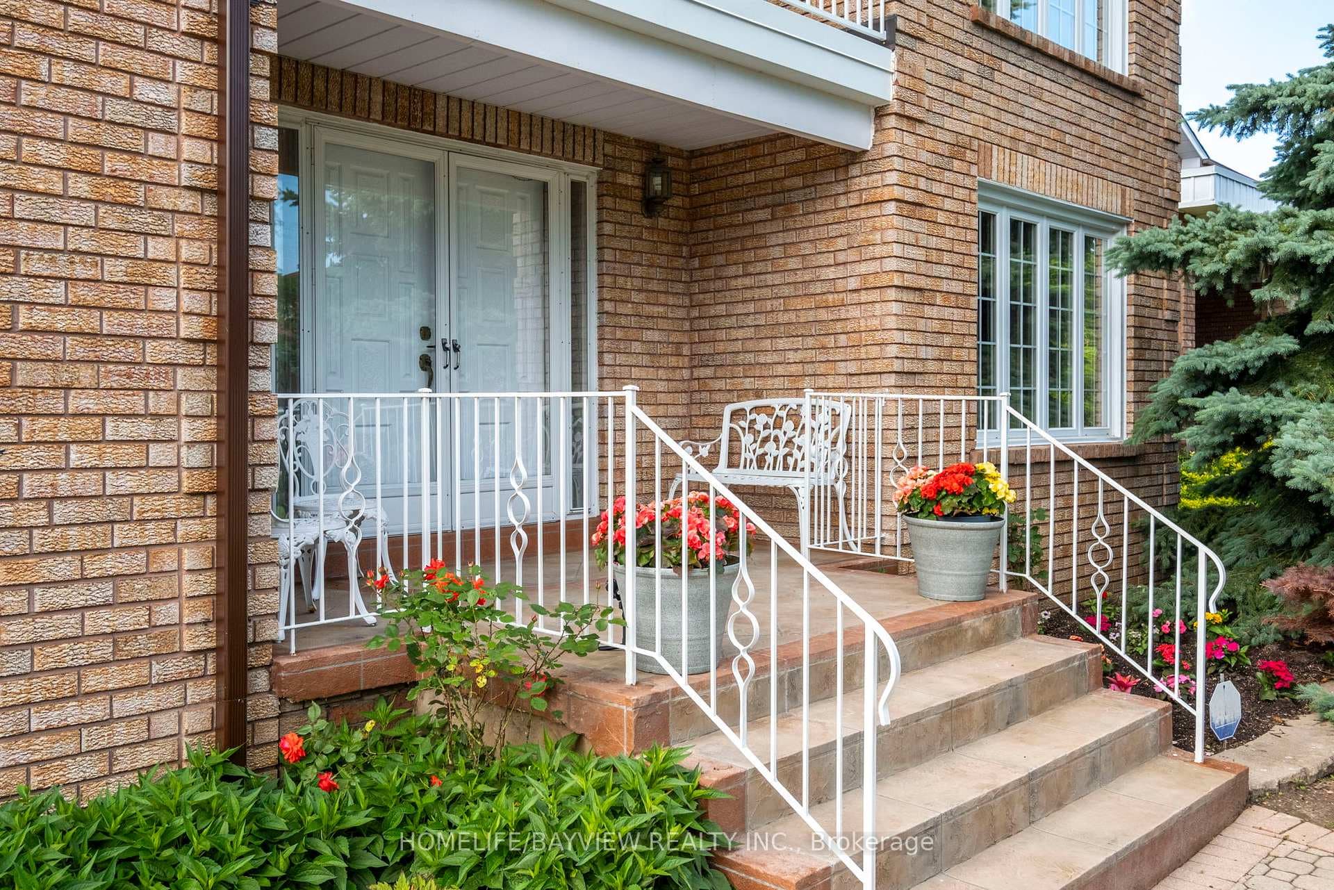 Inviting Front porch Entrance with side gardens