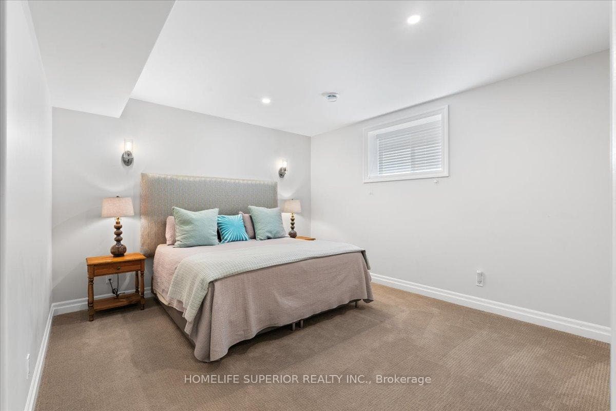LARGE BEDROOM WITH SCONCES, AND LARGE WINDOW