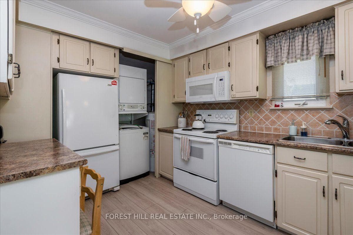 Stackable washer & dryer located in the kitchen.