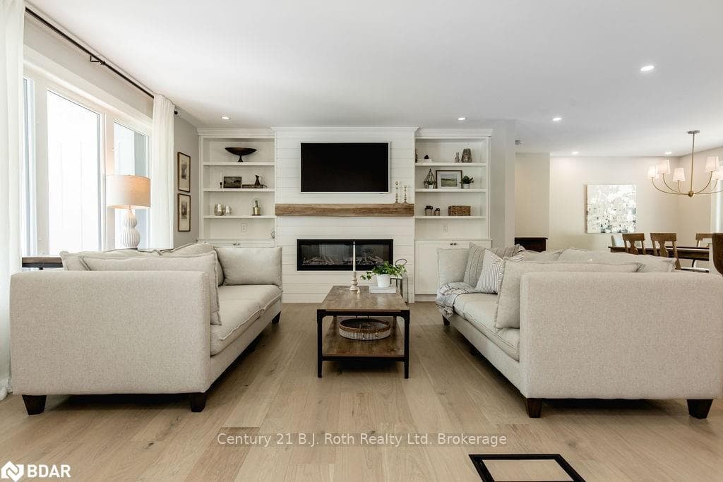 Living room featuring a fireplace, a chandelier, a