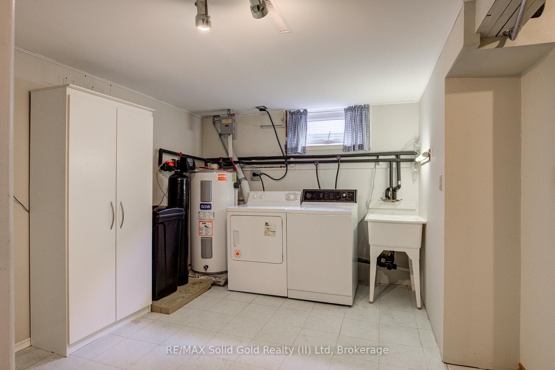 Spacious laundry area, water heater, and softener