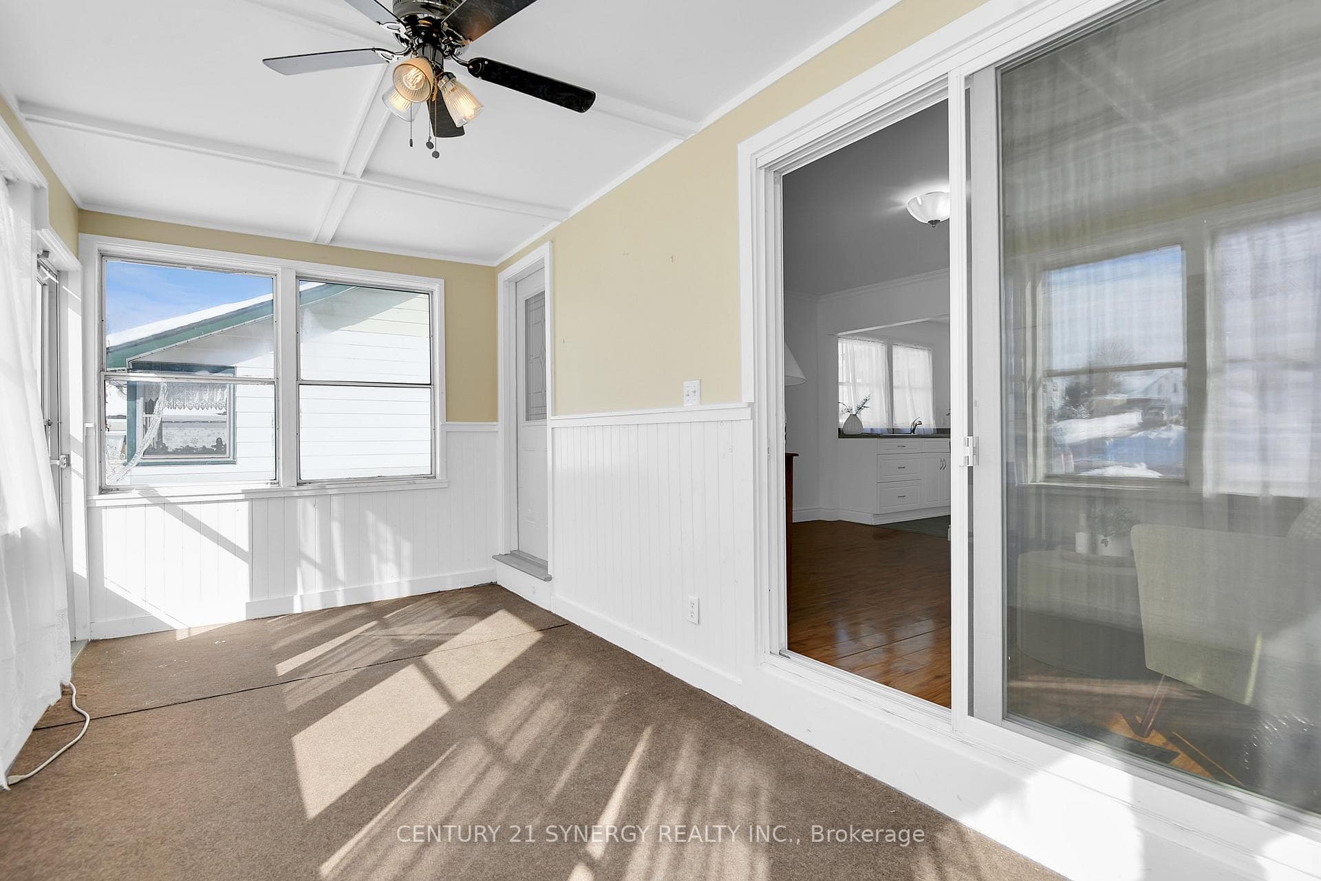 Patio doors lead to sunroom from living space.