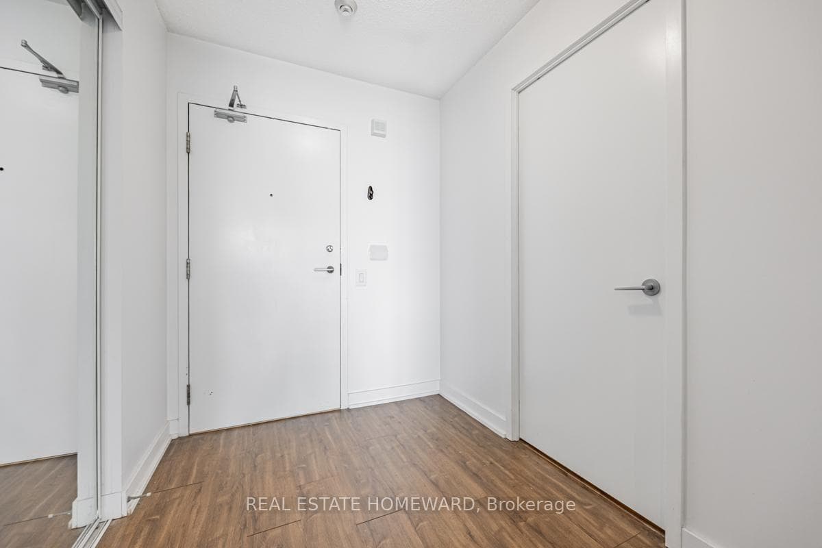 Foyer with Mirrored-Door Coat Closet