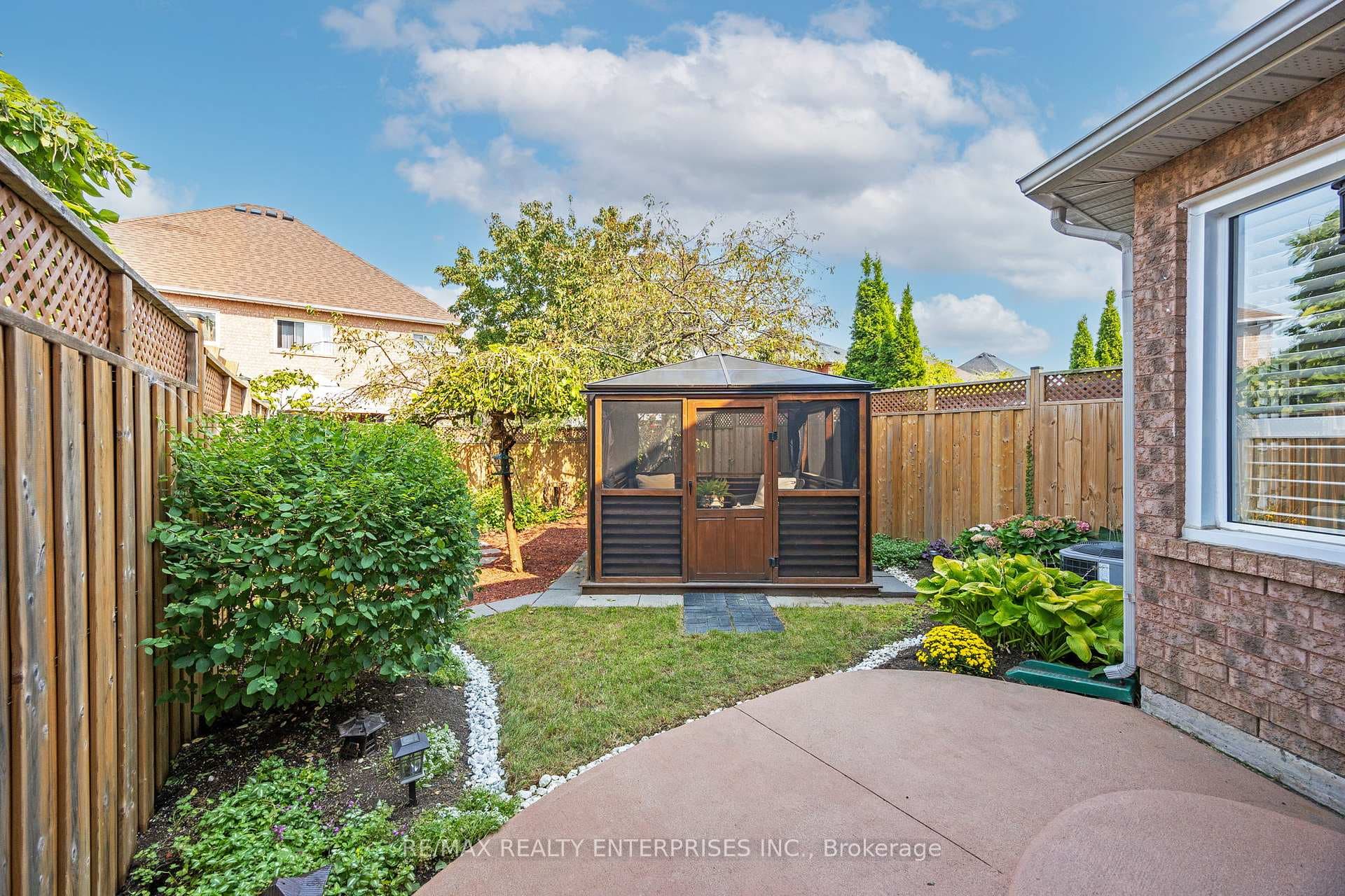Landscaped backyard with screened-in gazebo