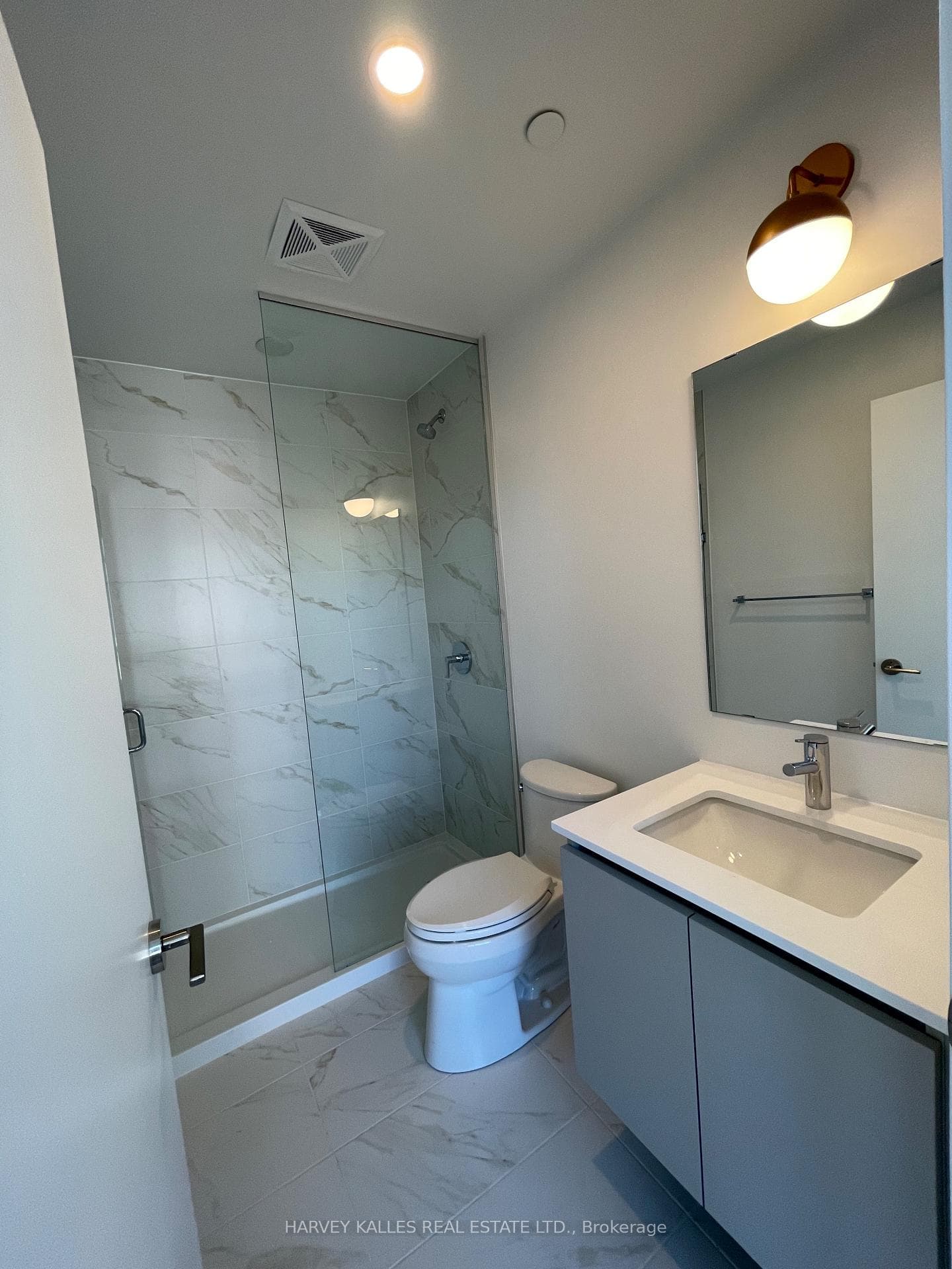 en-suite w/ glass shower and floating vanity