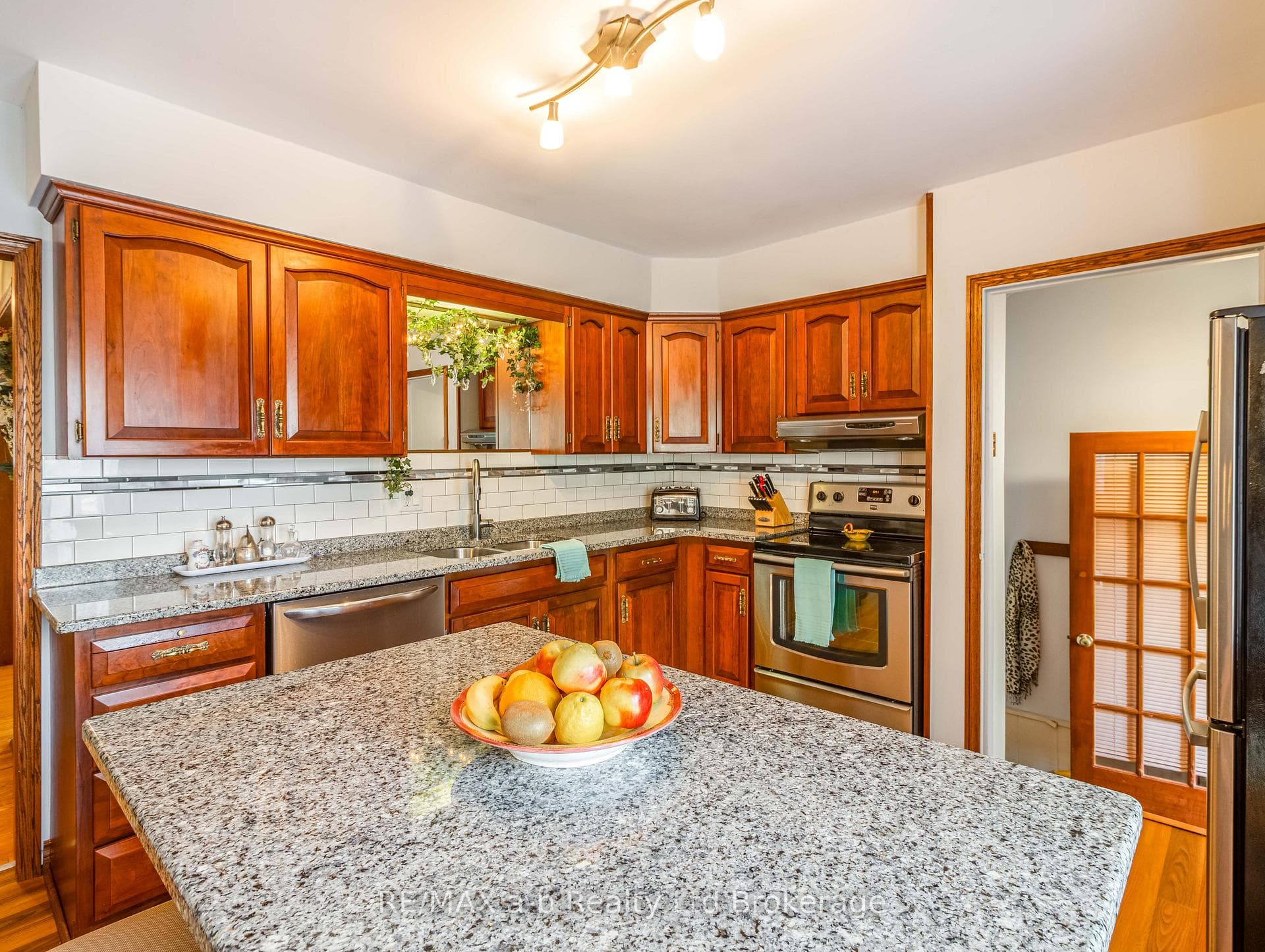 Main kitchen with island and cherry cabinets