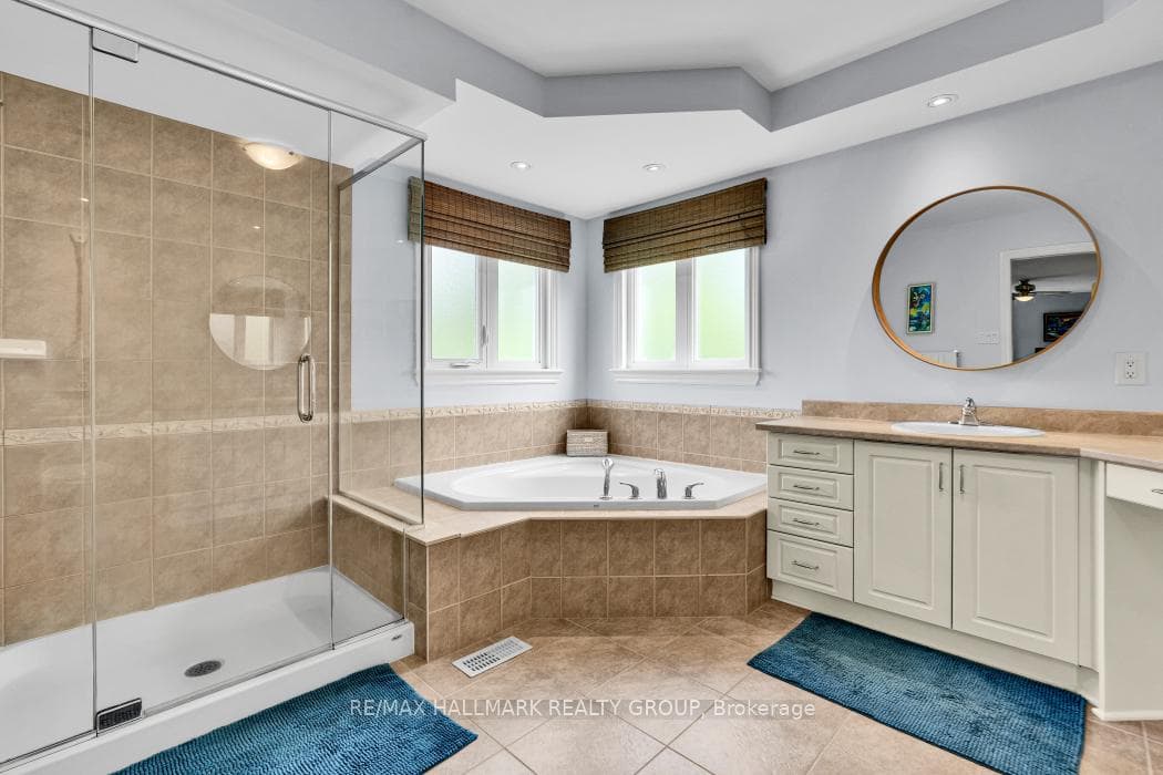 Huge soaker tub and glass enclosed shower.
