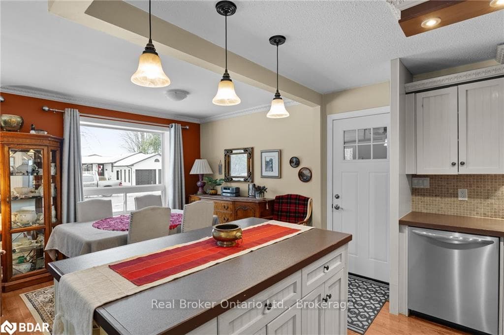 Kitchen featuring tasteful backsplash, hanging lig
