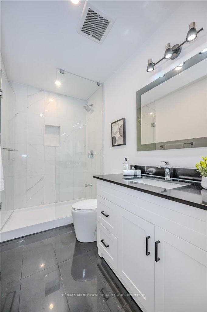 Renovated bathroom with glass shower door