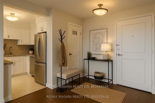 Digitally staged - Sunlit foyer in condo unit