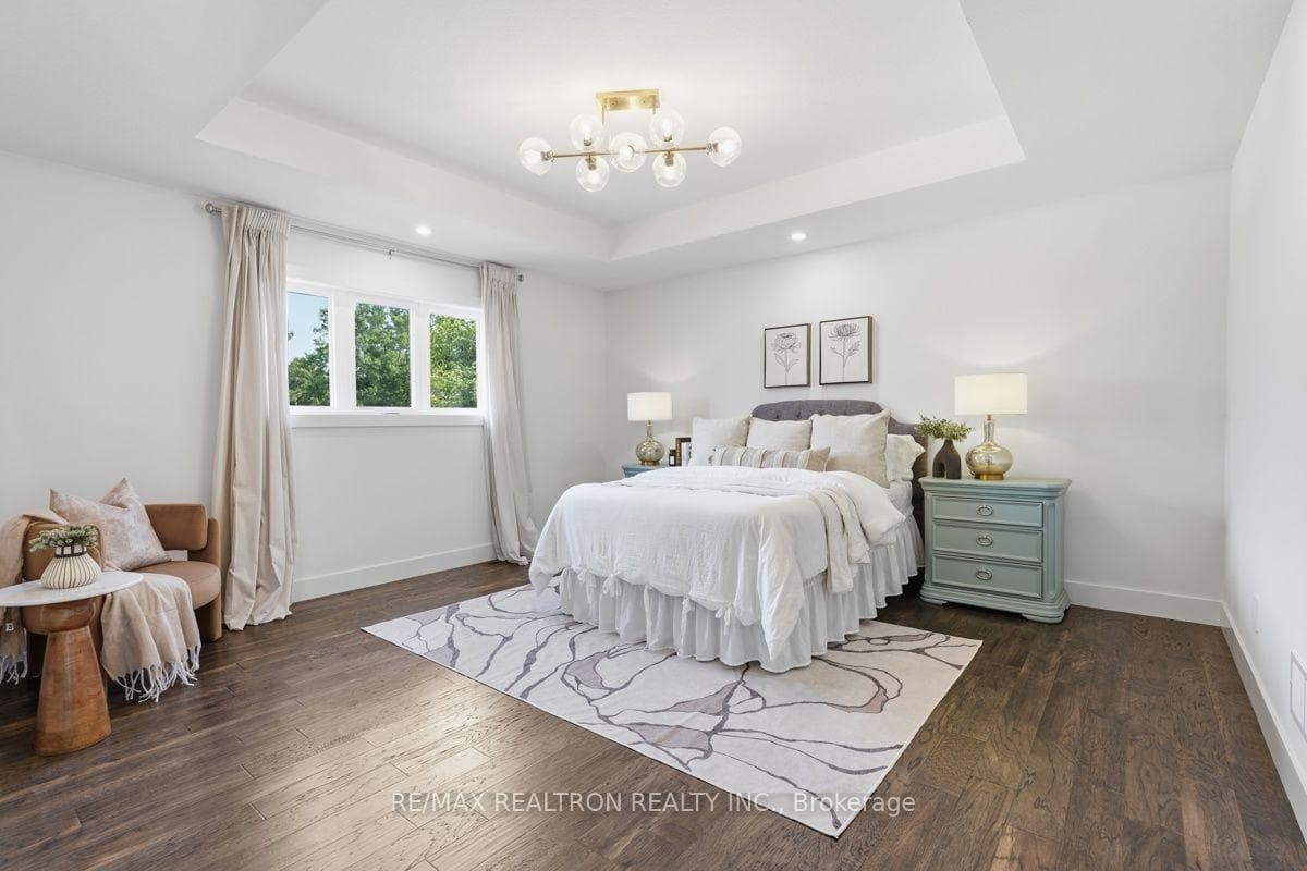Primary bedroom with tray ceiling.