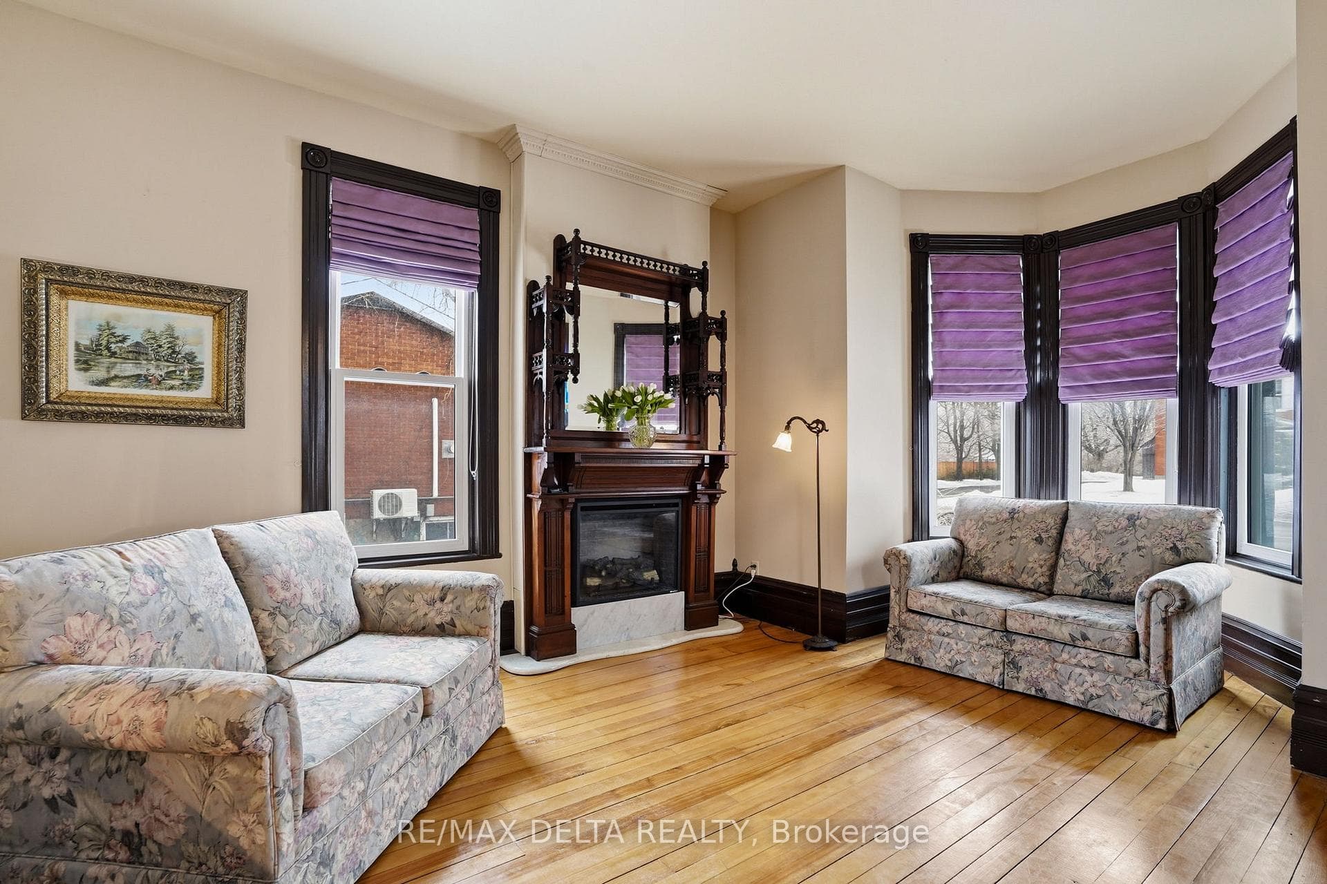 Parlour with bay window, electric fireplace.