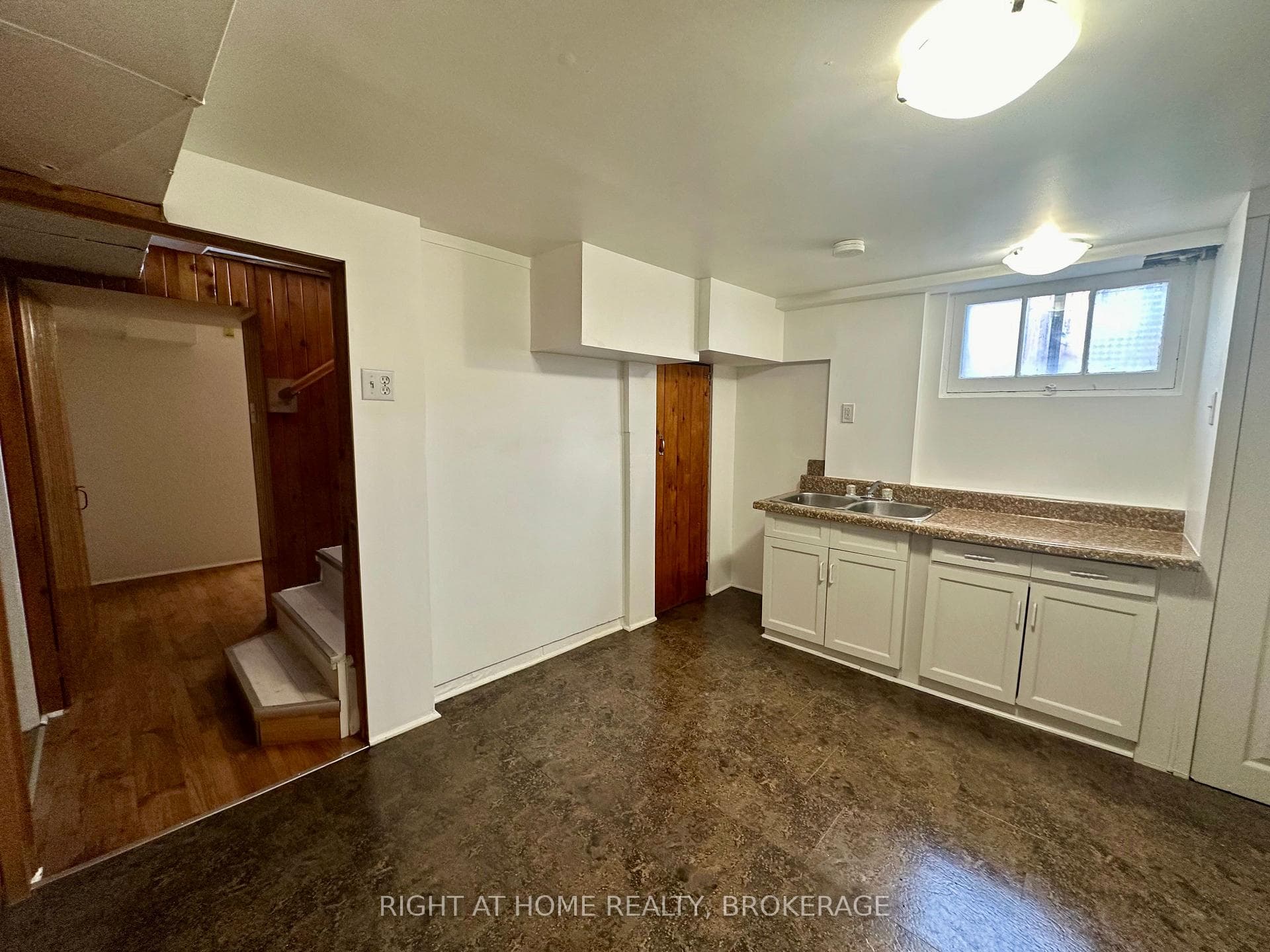 Basement eat-in Kitchen with white cabinetry