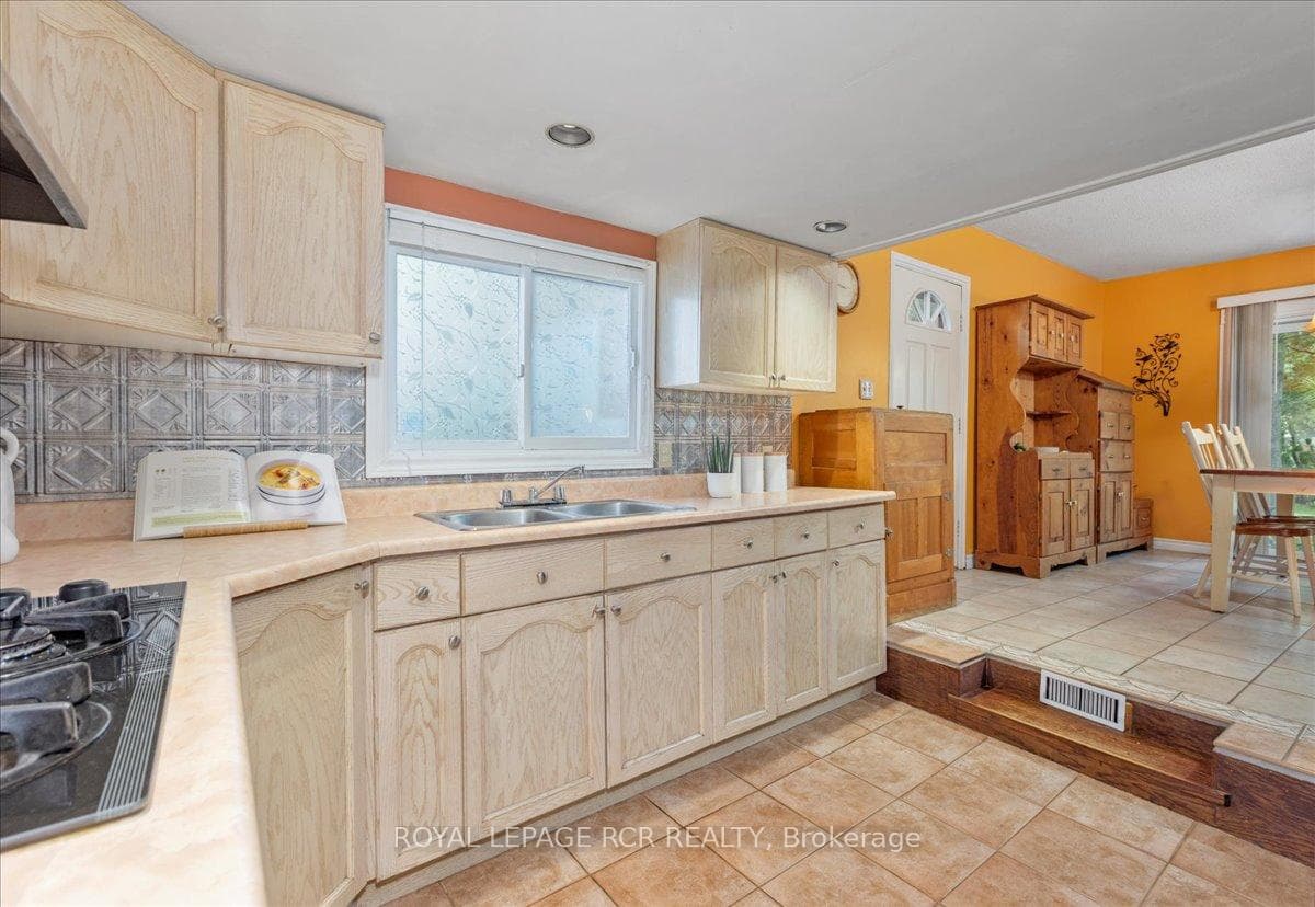 Kitchen: Ample Cabinetry , Step-up to Dining Room