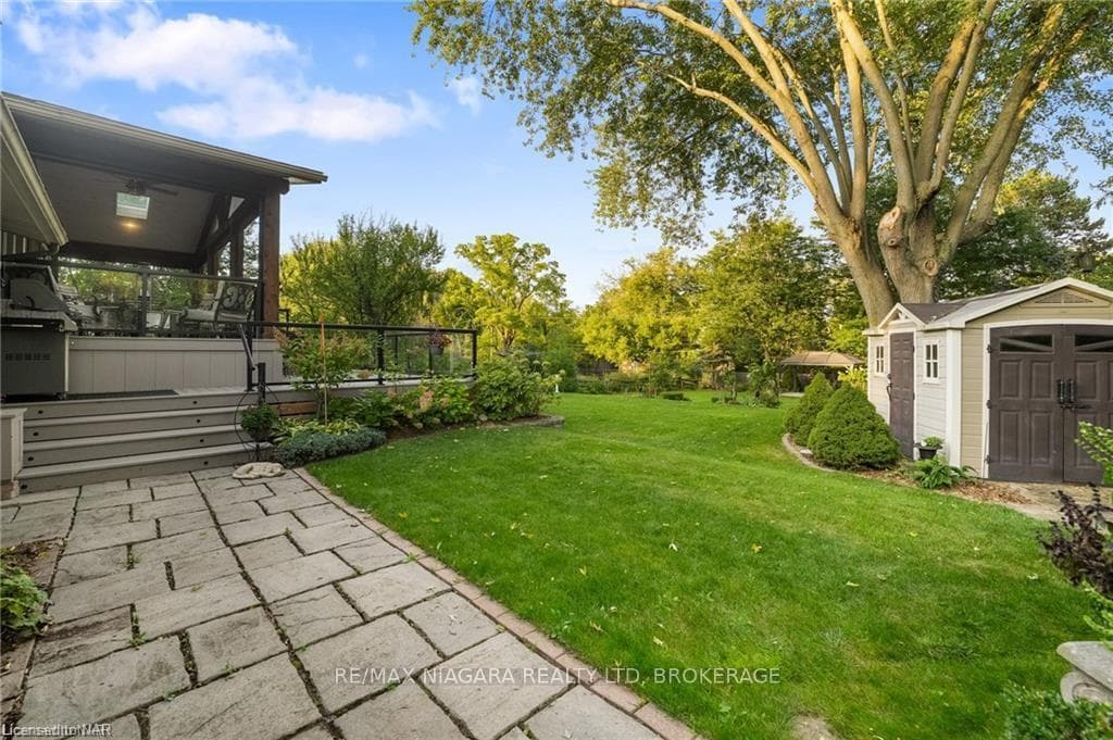 View of yard featuring a shed and a patio