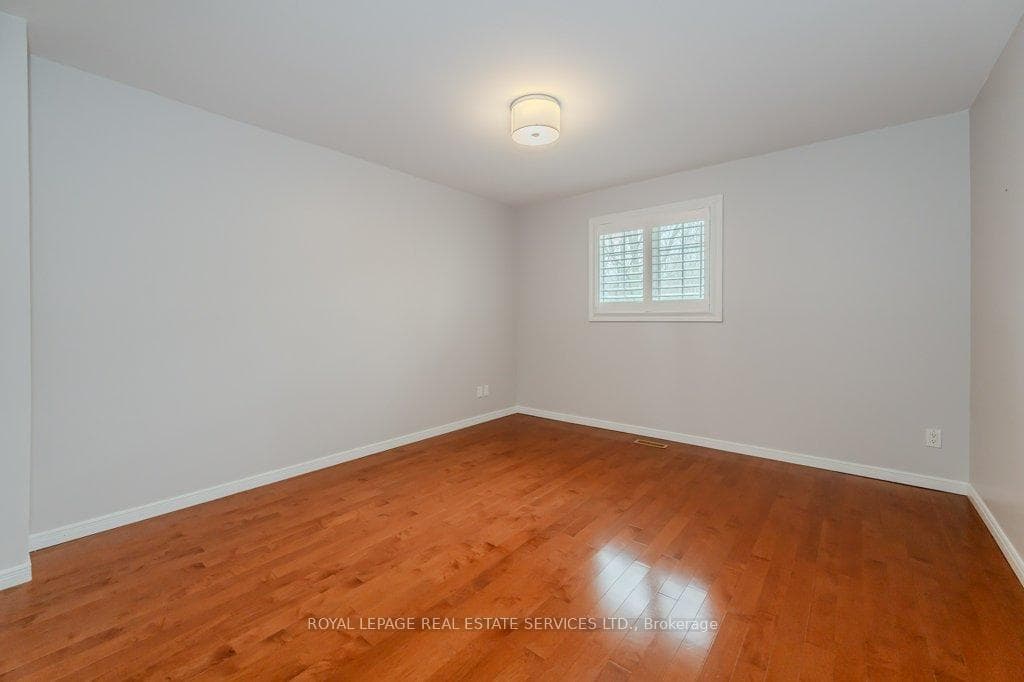 Fourth Bedroom w/ a Hardwood Floor & Cali Shutters
