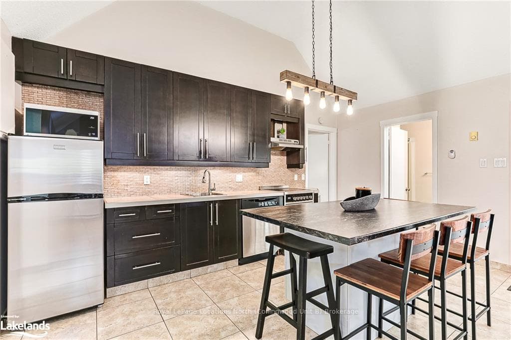 Kitchen with stainless steel appliances, sink, a k