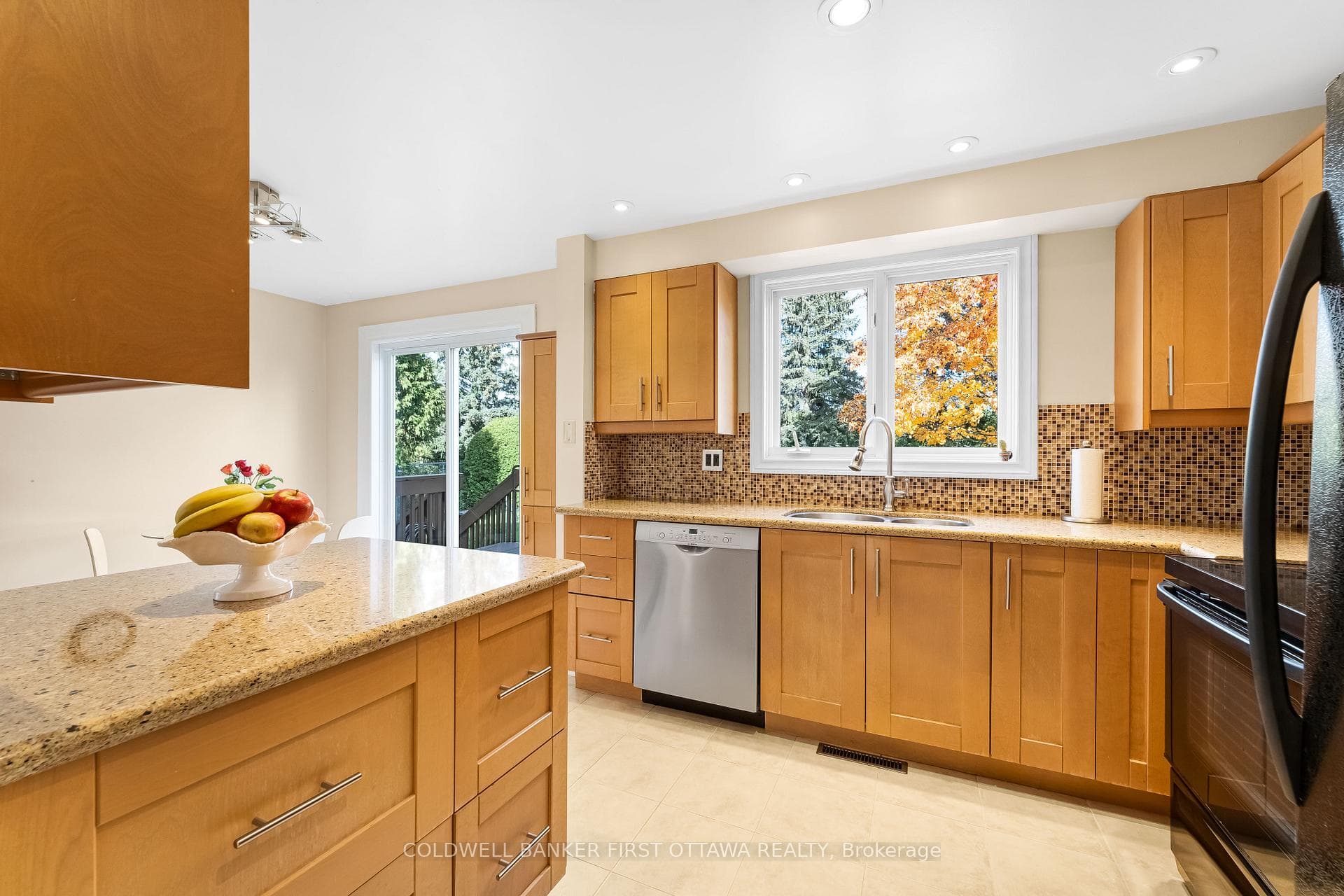 Window over sink with view of backyard.