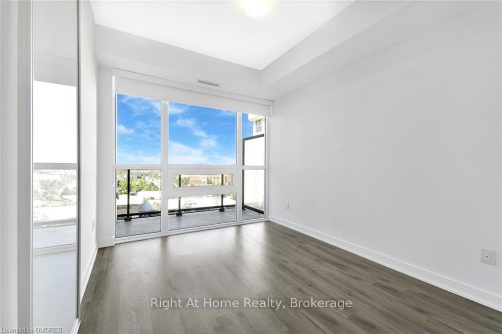 Empty room with dark hardwood / wood-style floorin