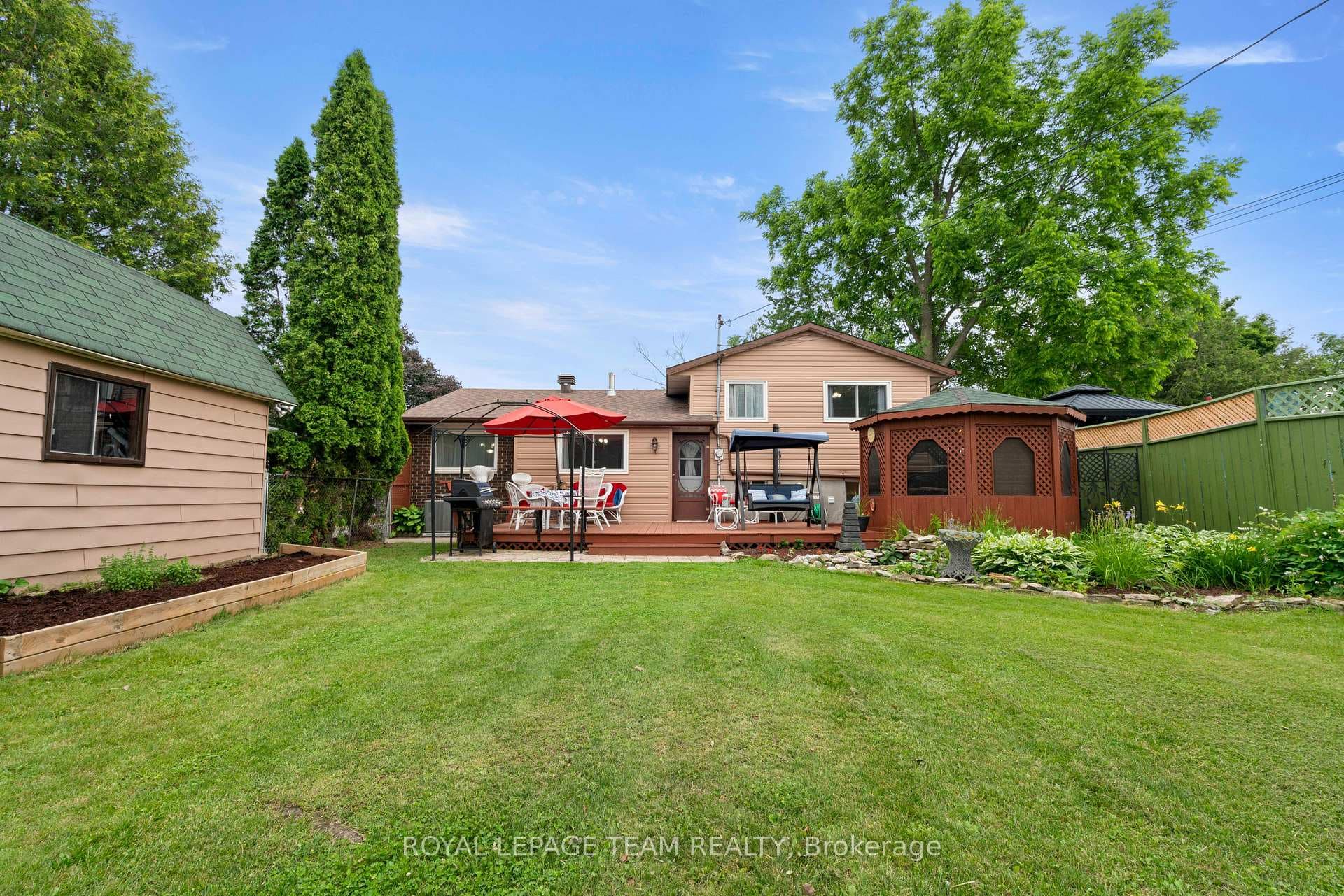 Spacious rear yard with mature trees for privacy
