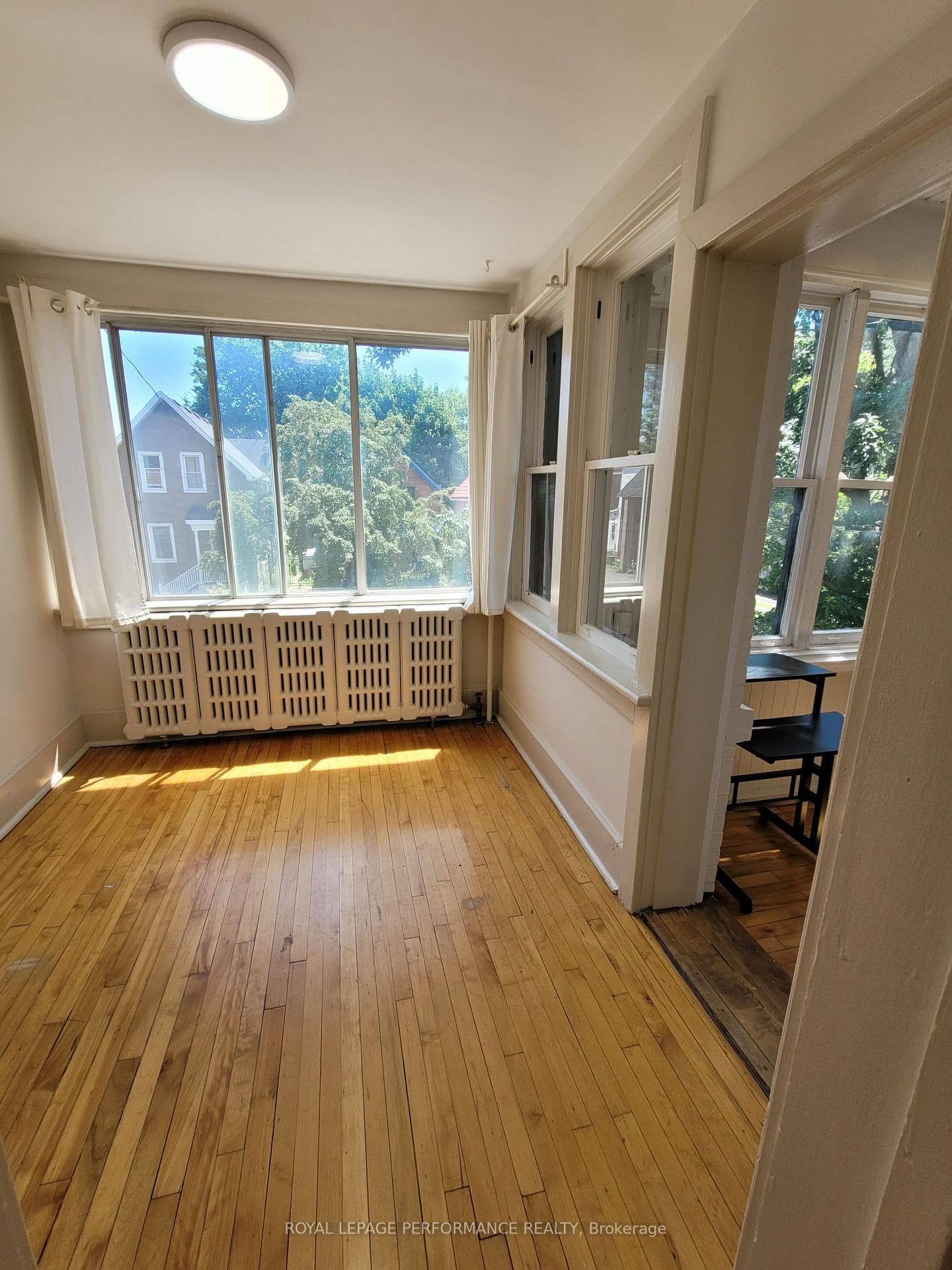 Small, bright bedroom, small office area, right