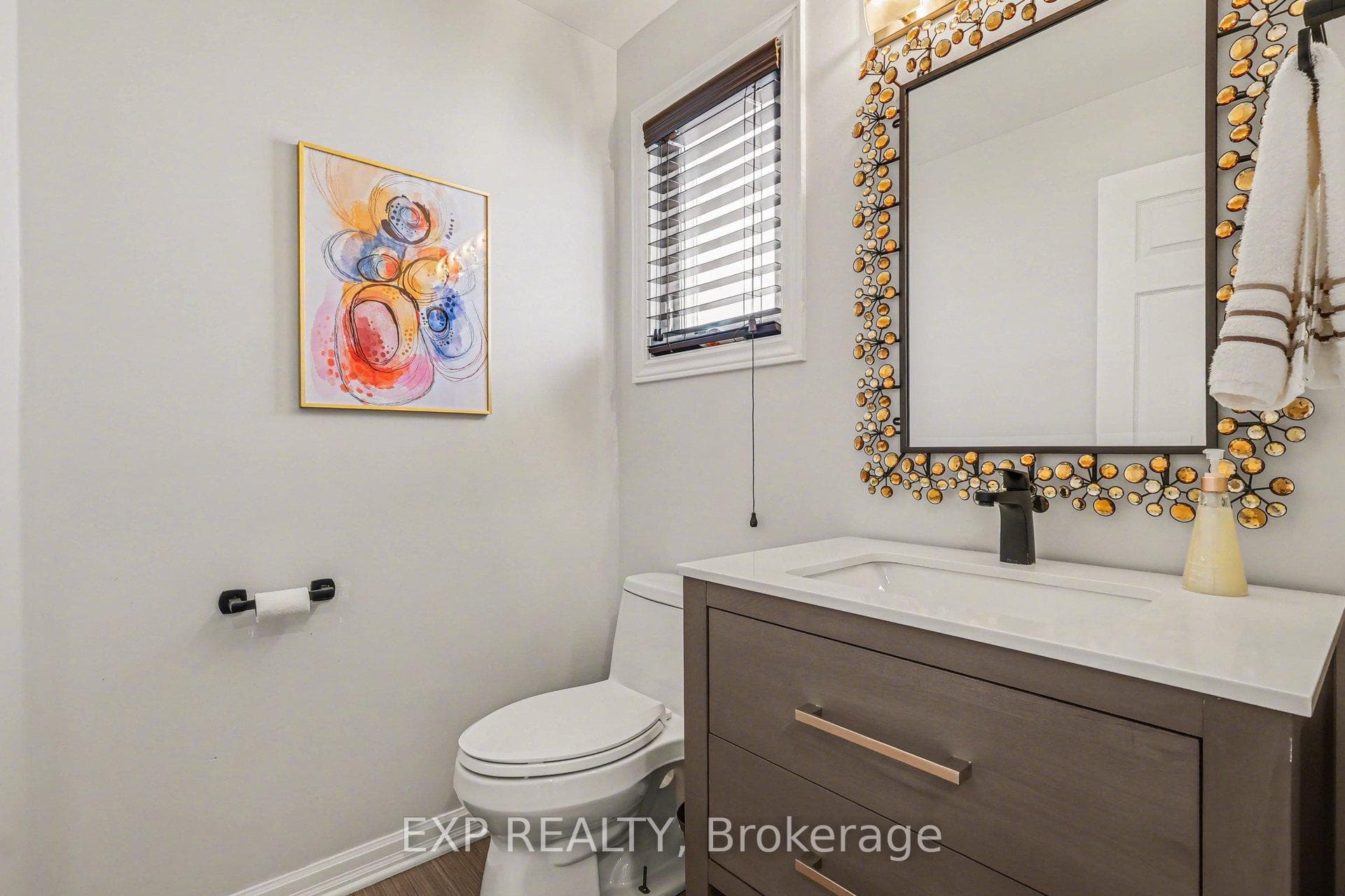 Main level powder room located off of the foyer.