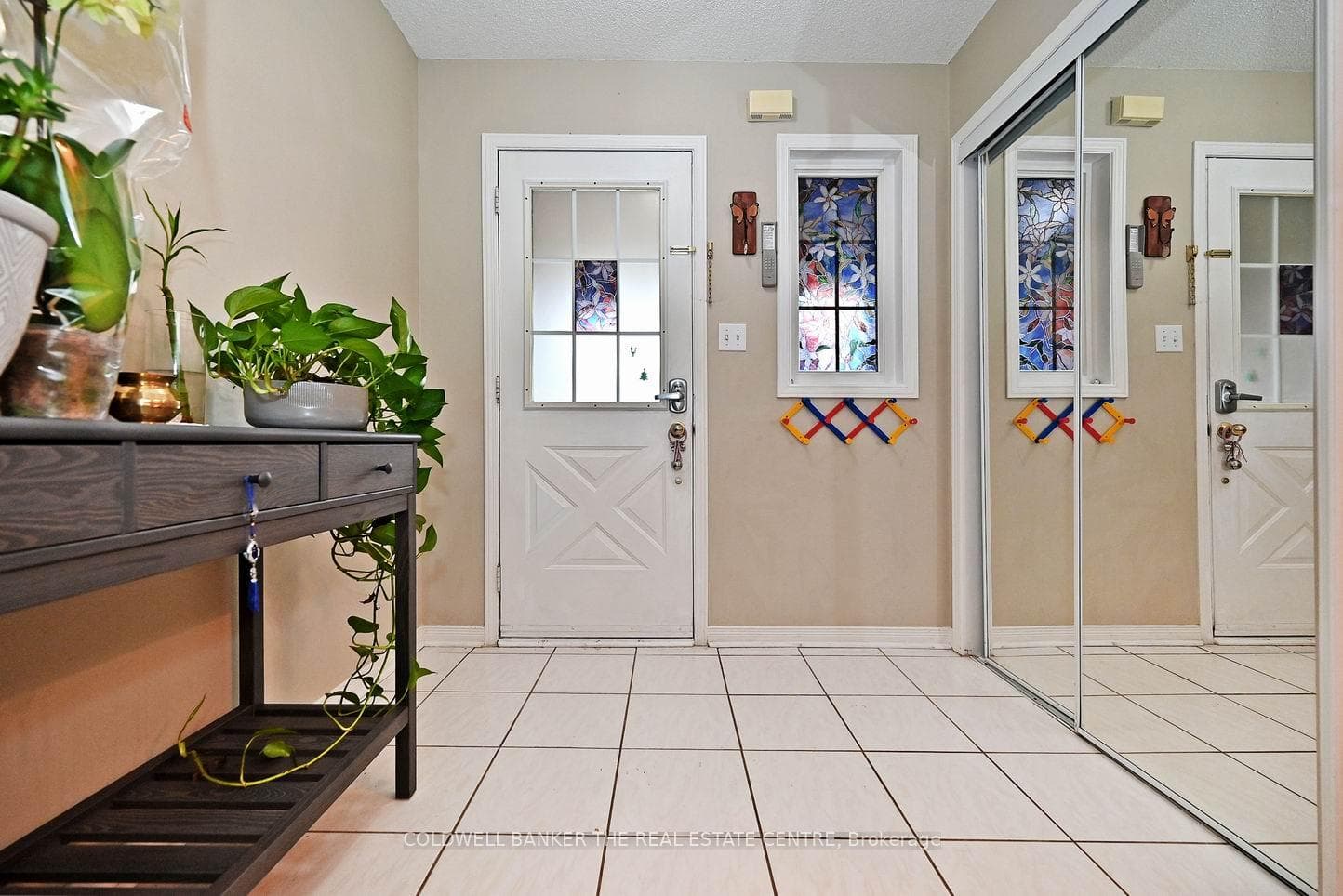 wide foyer with glass mirrored closet