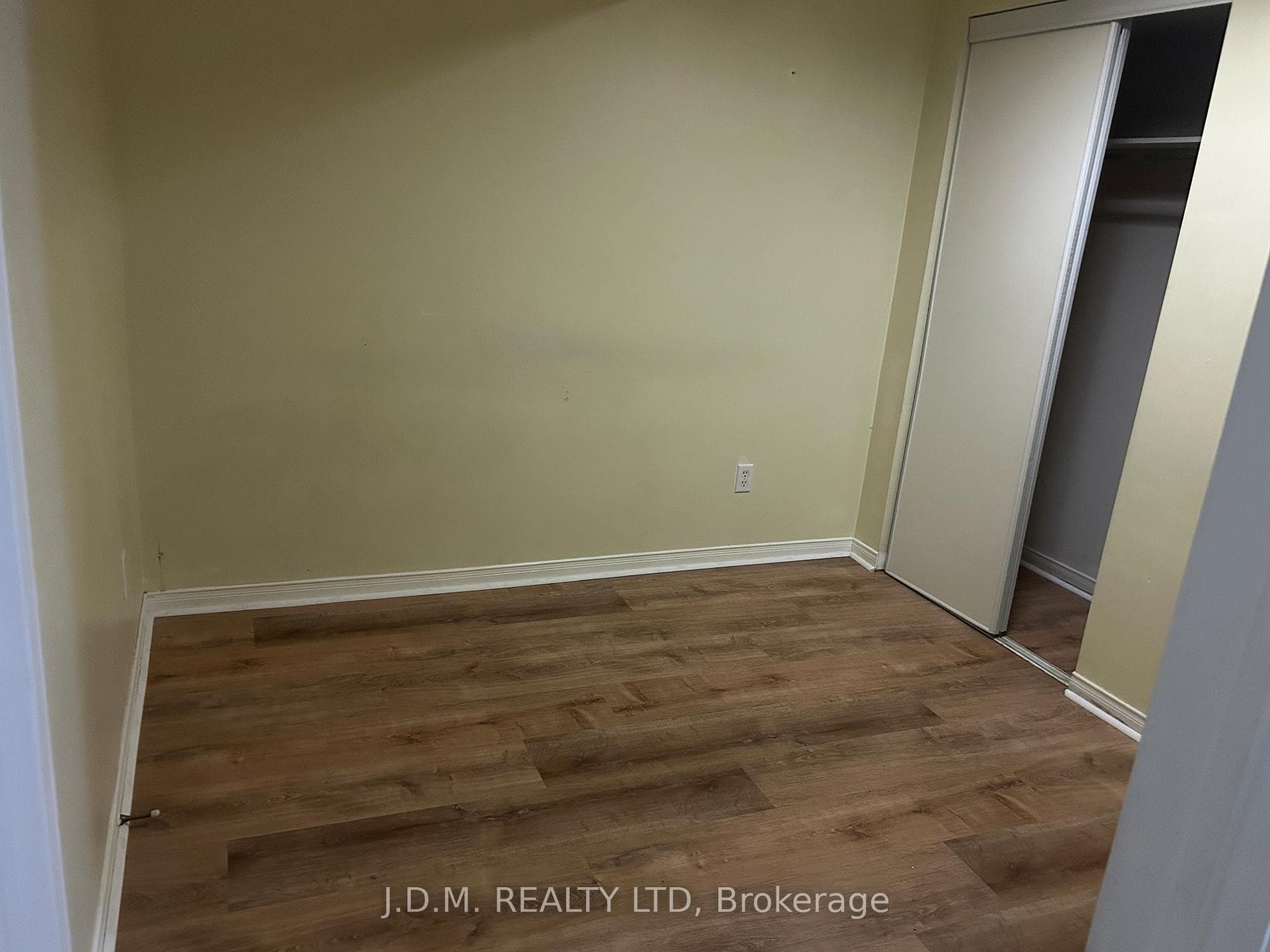 Laminate floors and double closet in the bedroom.