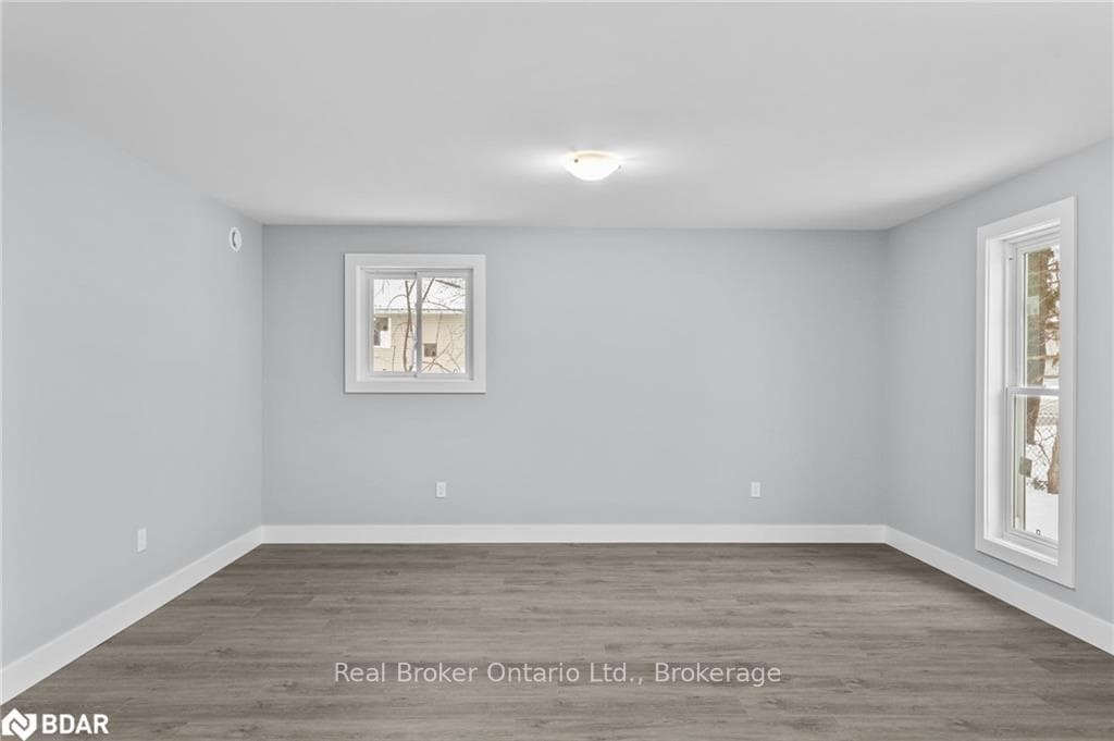 Spare room featuring wood-type flooring