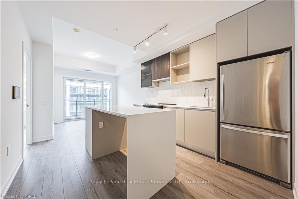Kitchen featuring stainless steel refrigerator, si