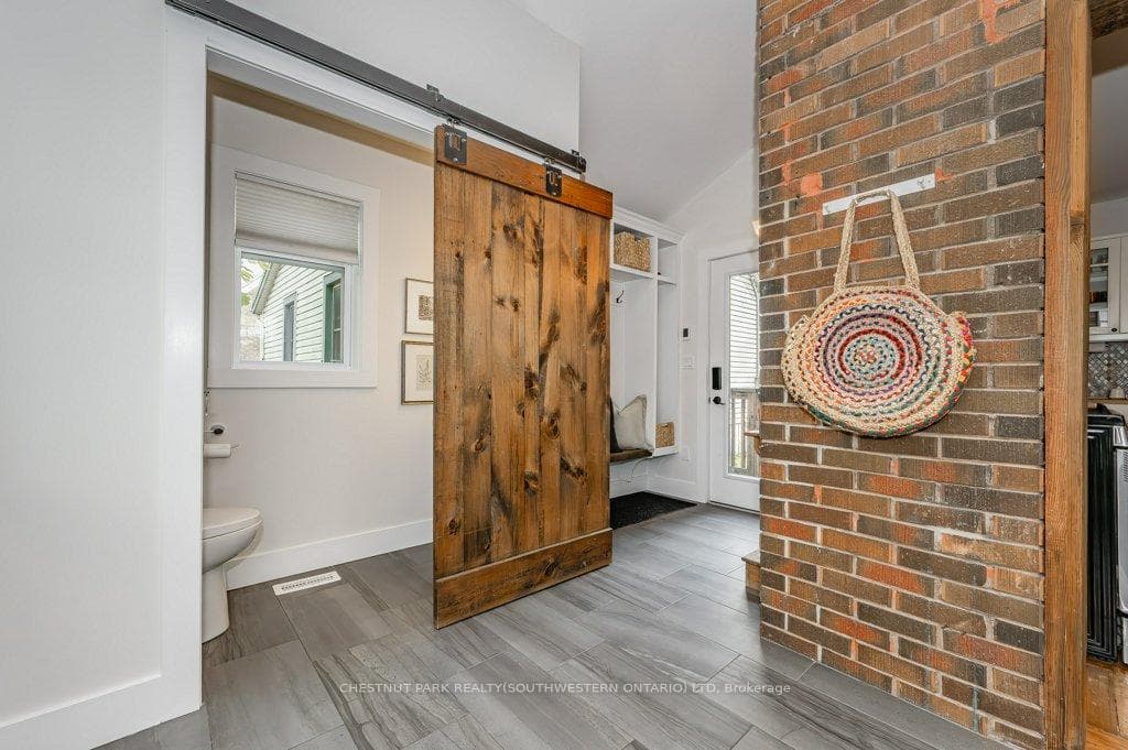 Barndoor leading to a 2-pc bathroom