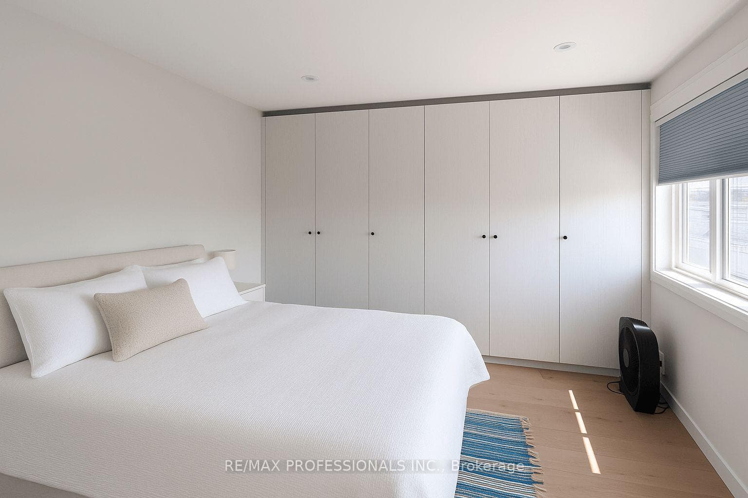 Primary bedroom with wall of built-in closet