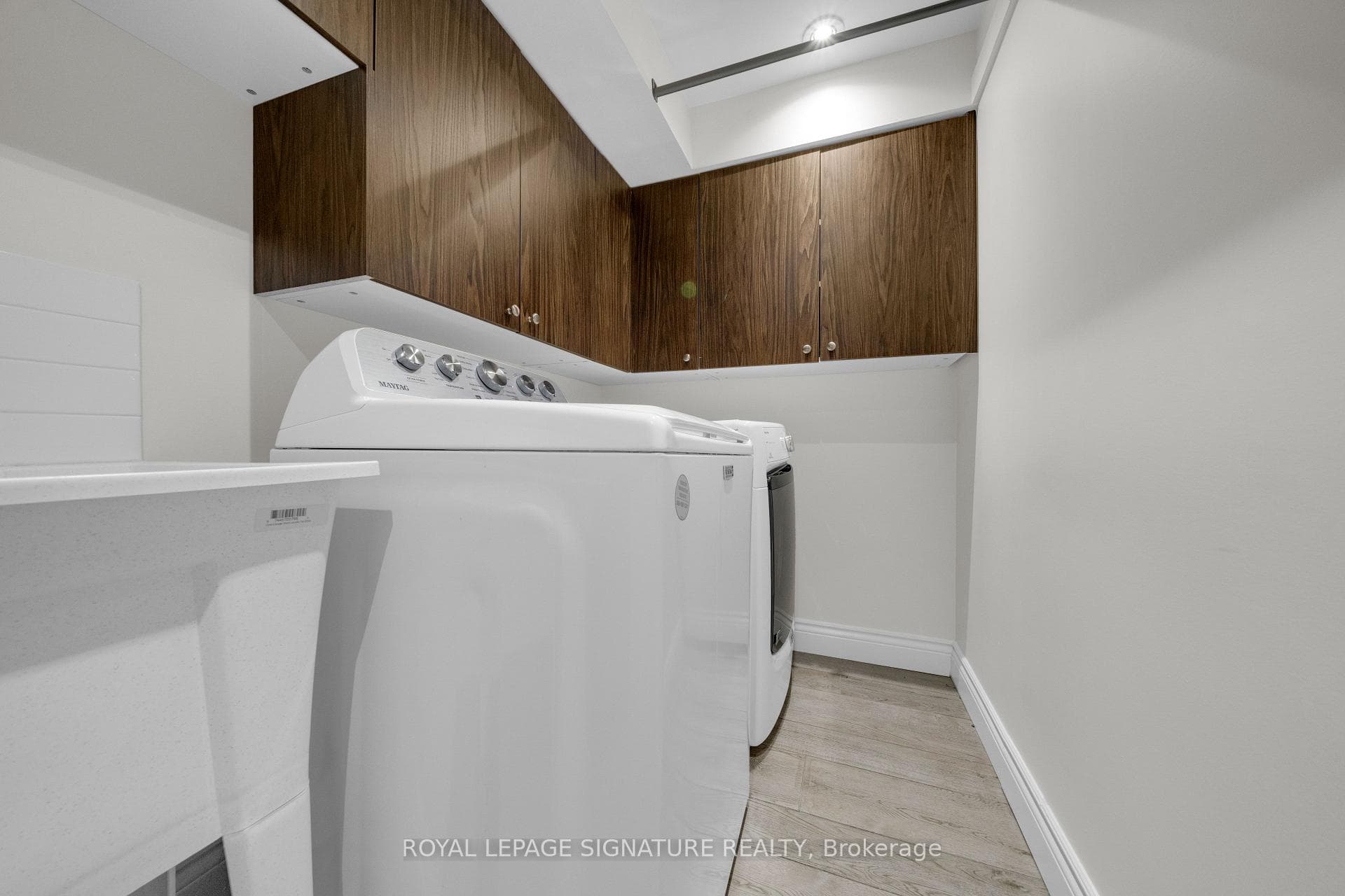 Renovated Laundry Room with Storage Cabinets