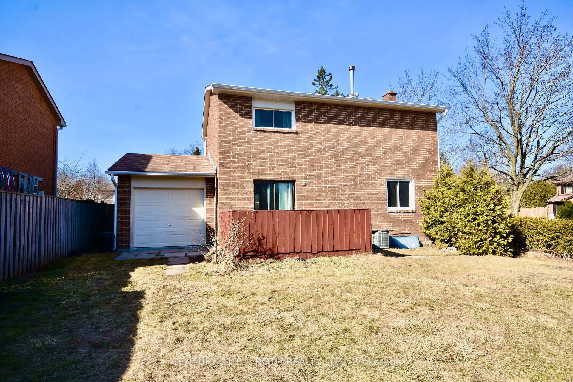 Fully fenced backyard with tandem garage.
