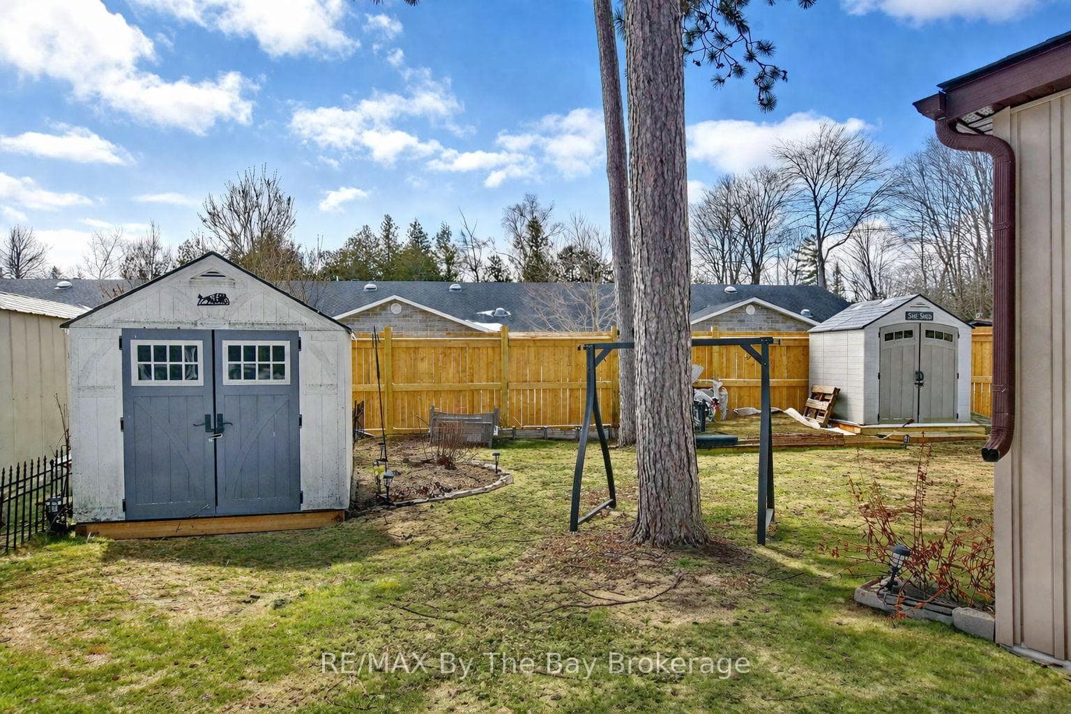 Backyard with @ sheds and Mostly Fenced Yard